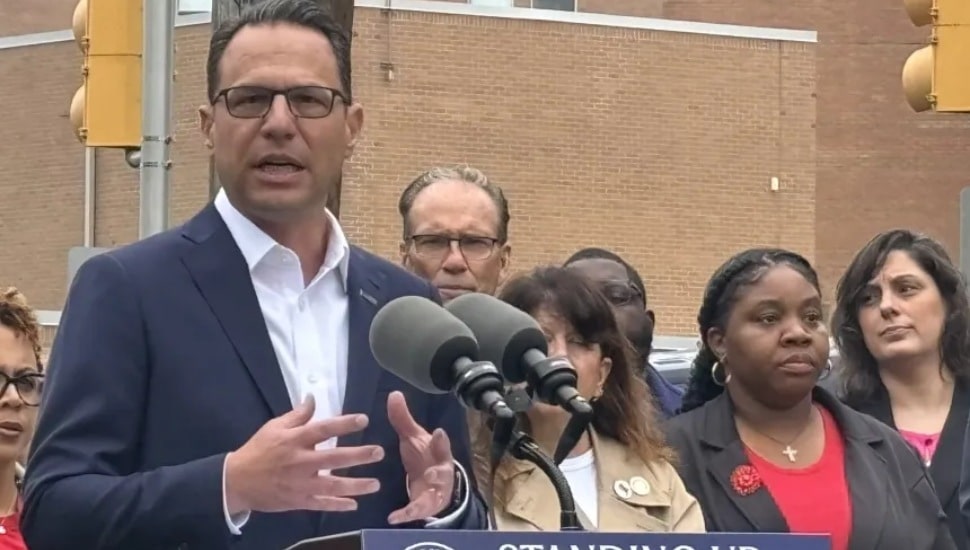State Rep. Carol Kazeem, right, in red blouse and black blazer, during a press conference Thursday with PA Gov. Josh Shapiro outside the closed Crozer-Chester Medical Center.