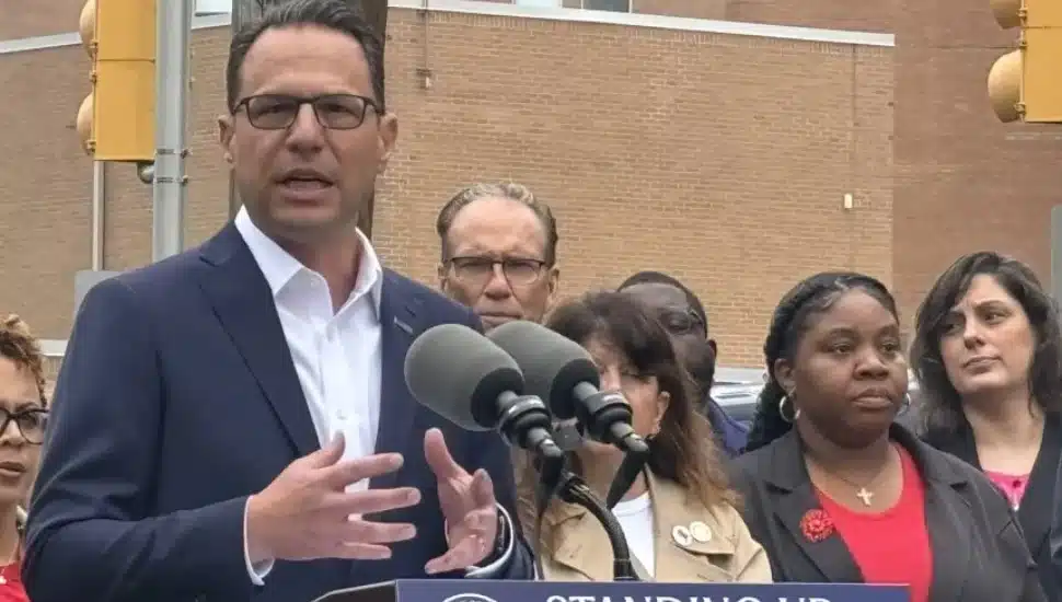 State Rep. Carol Kazeem, right, in red blouse and black blazer, during a press conference Thursday with PA Gov. Josh Shapiro outside the closed Crozer-Chester Medical Center.
