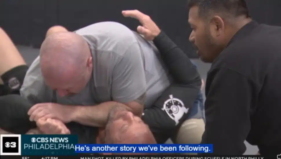 Mike Egan and Pisey Tan practice a Jiu-Jitsu maneuver at The Vault in Morton as an instructor looks on.