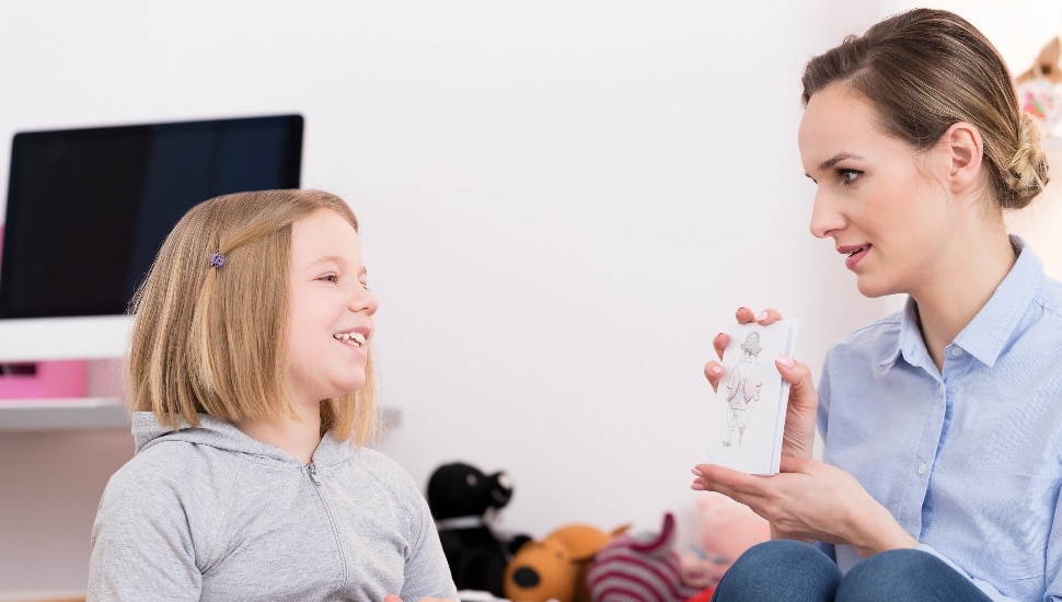 A mom has a sex education discussion with her daughter at home.