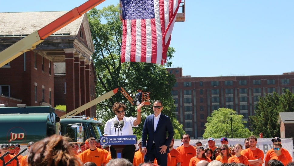 PA Gov. Josh Shapiro at a podium with an American flag above at the Philadelphia Navy Yard.