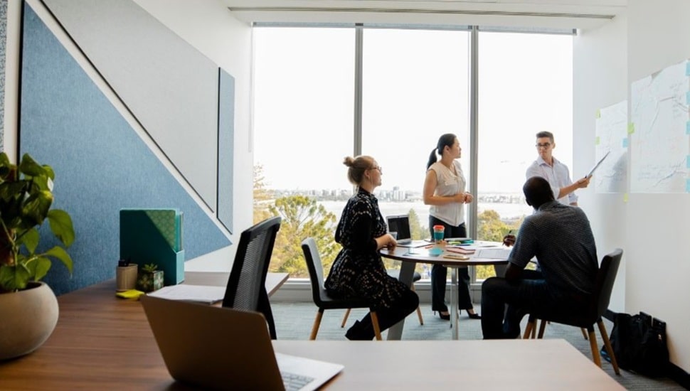 Workers discuss business strategy in a conference room.