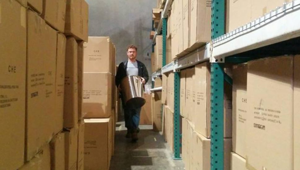 Abington's Steve Schnarr surrounded by boxes of brewing equipment.