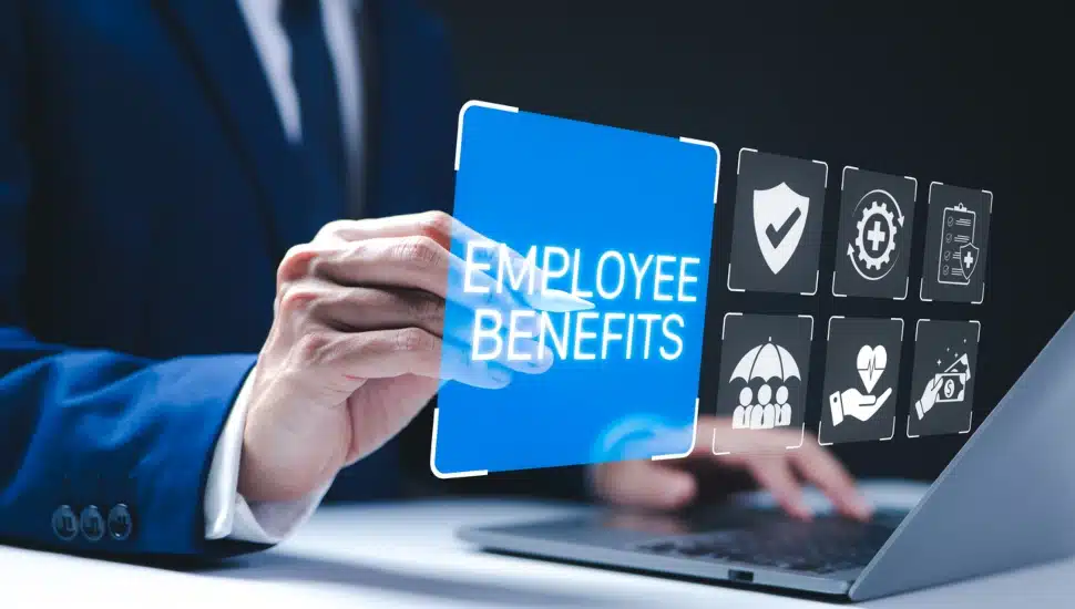 A businessman operates a digital interface to look at employee benefits.