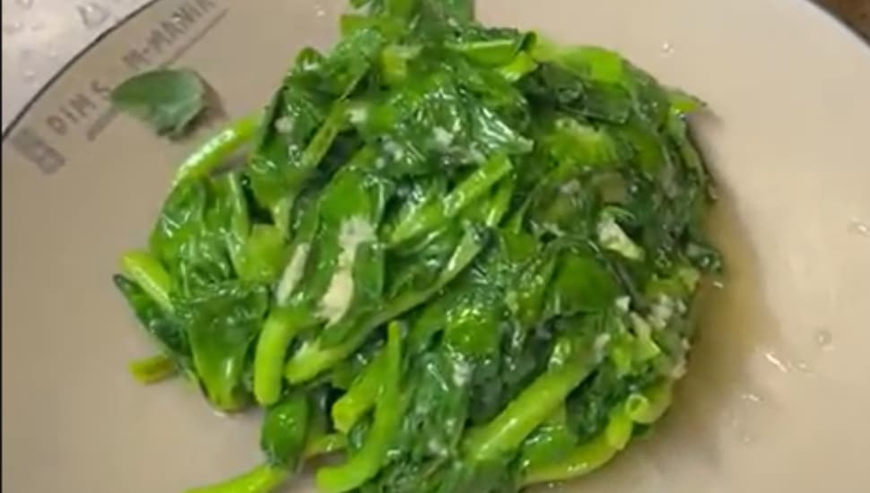 A plate of freshly-cooked snow pea leaves.