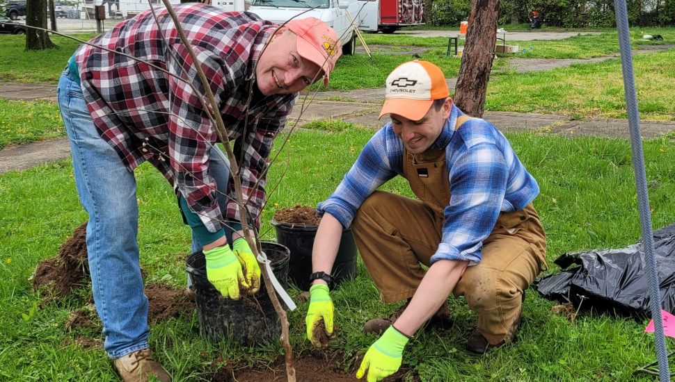 Members of the Delaware County Office of Sustainability plant a tree at a 2024 Earth Day event.