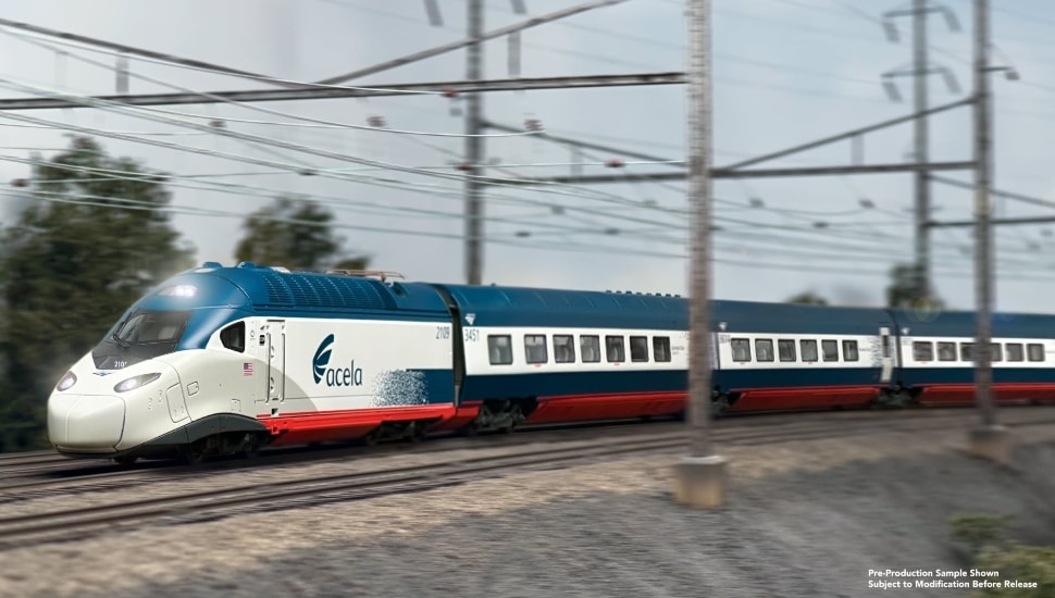 An Acela model train traveling on the tracks.