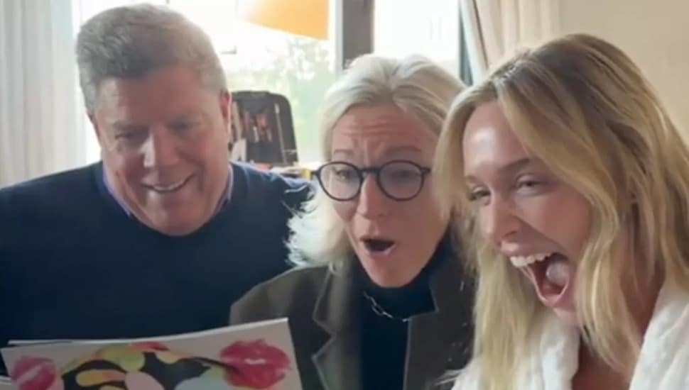 Alex Cooper sings a piece of music with her parents.