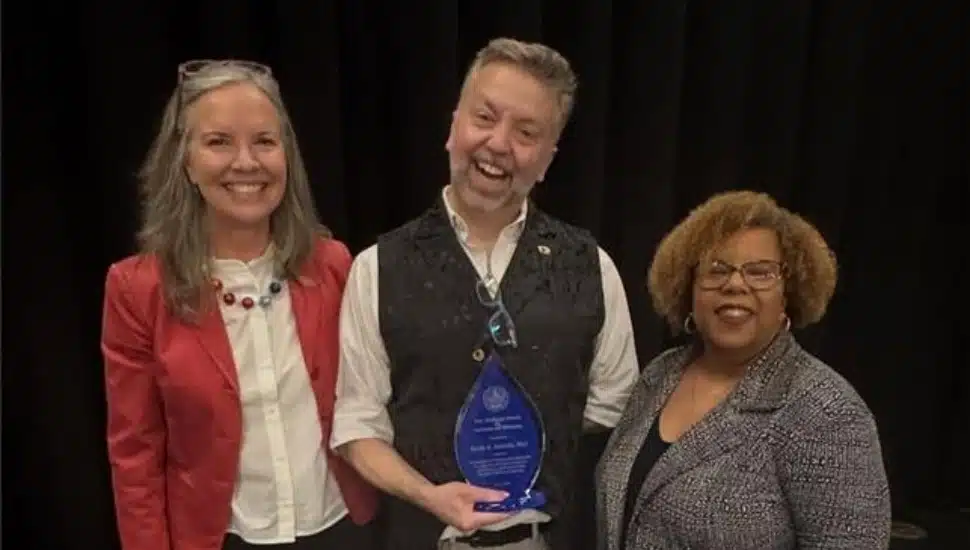 Professor Brent Satterly, (center), stands with Widener President Stacey Robertson (left) and Micki Davis, vice president of Inclusion and Belonging.