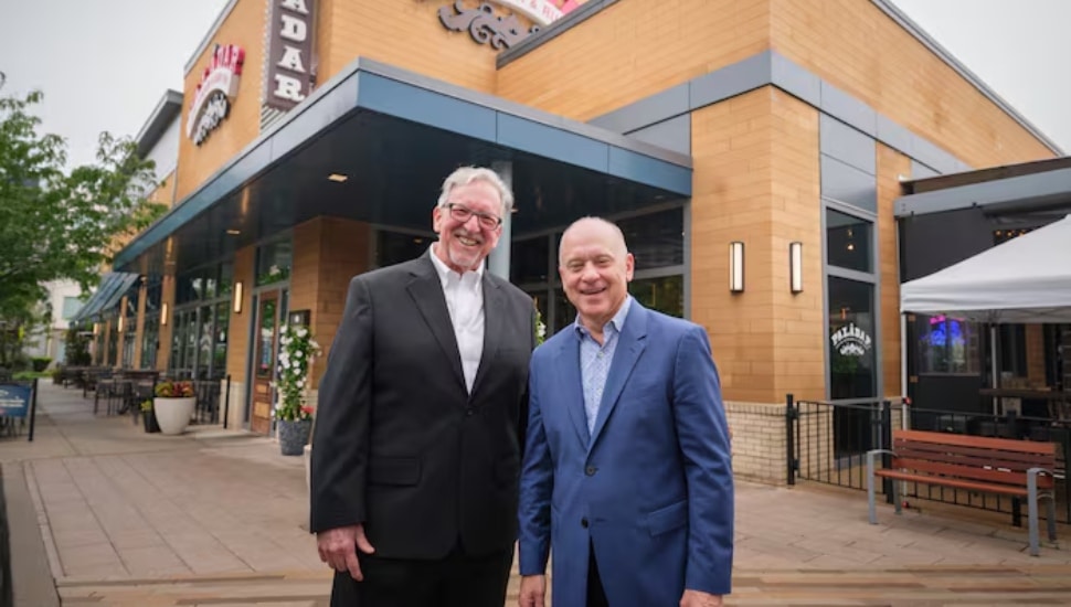 Restaurant partners Larry Cohen (left) and Barry Gutin stand in front of Bomba in Malvern.