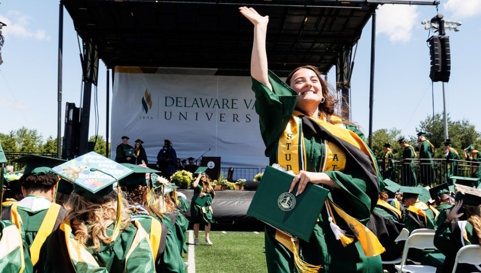 College graduate throws cap in the air at commencement.