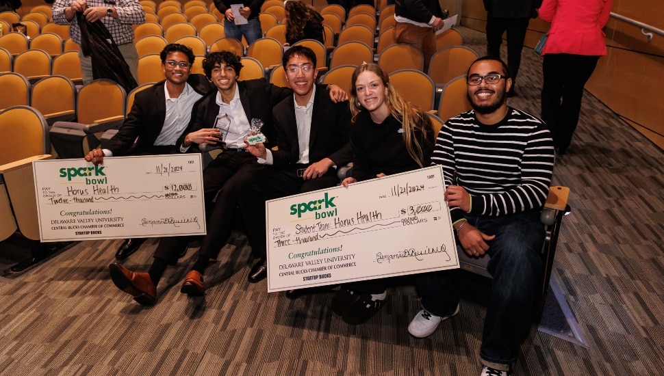 Student entrepreneurs receive big checks for competition victory.