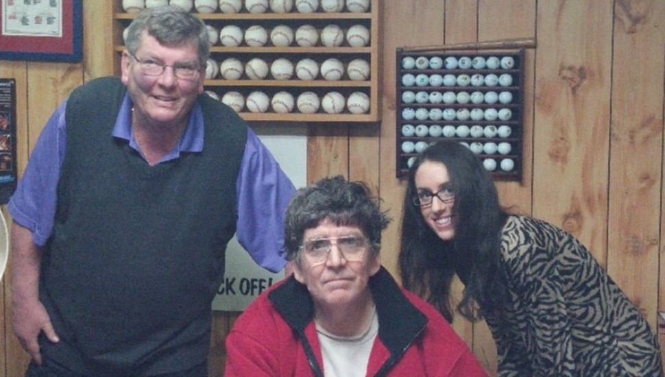Owners of family-run business pose for group photo.