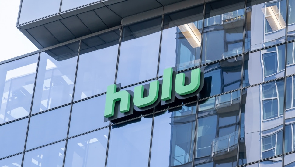 An outside look at Hulu offices with the Hulu sign on the glass building.