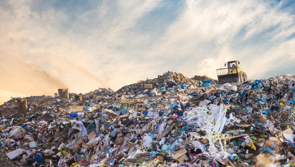A pile of trash and debris at a landfill.