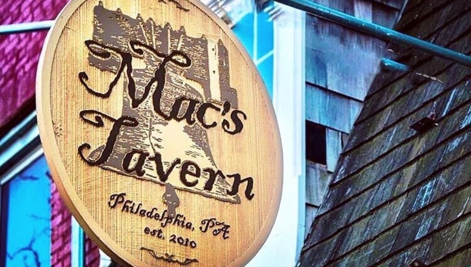 The outdoor hanging sign for Mac's Tavern.