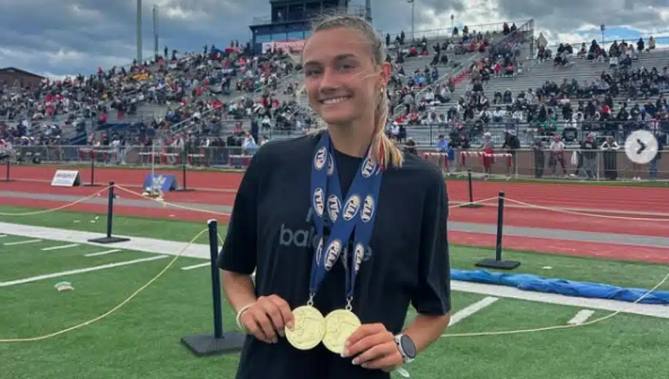 Olivia Cieslak holds two state gold medals she received after competing in the PIAA championships.