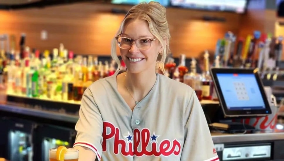 A woman bartender wears a Phillies shirt at PJ Whelihan's.