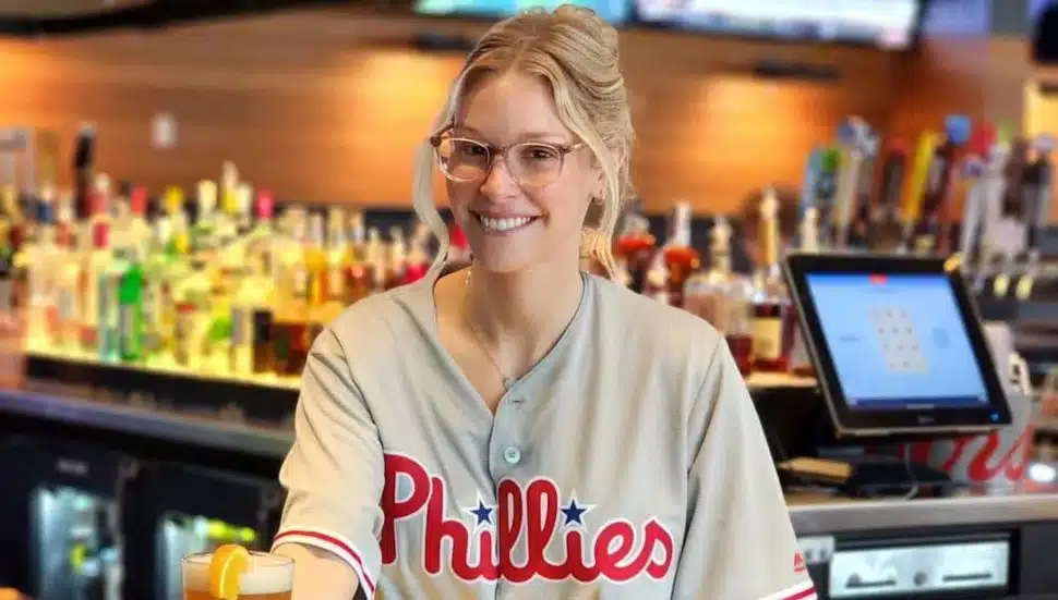 A woman bartender wears a Phillies shirt at PJ Whelihan's.