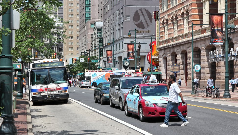 A Philadelphia street crowded with cars, buses and pedestrians.