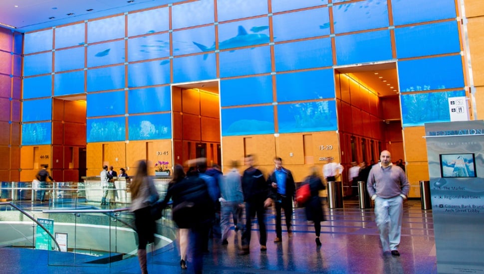 People walking inside the Comcast building in Philadelphia.
