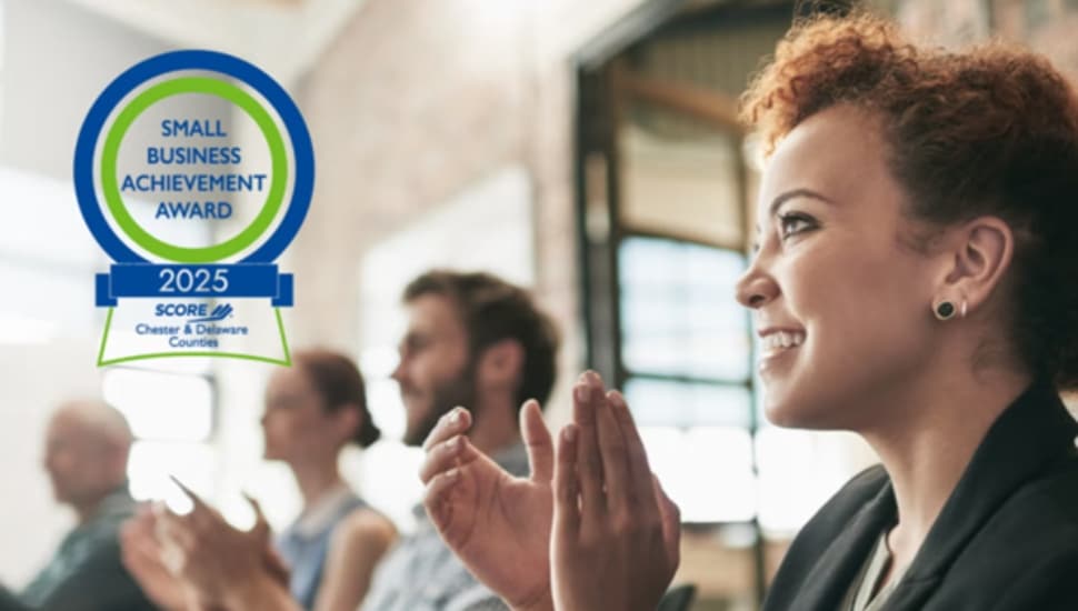 A group of entrepreneurs at an event are clapping for a presenter.