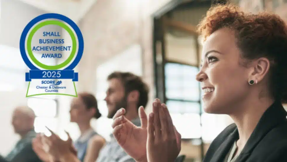 A group of entrepreneurs at an event are clapping for a presenter.