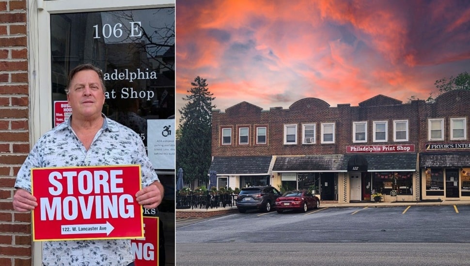 Store owner holds moving sign next to new location.