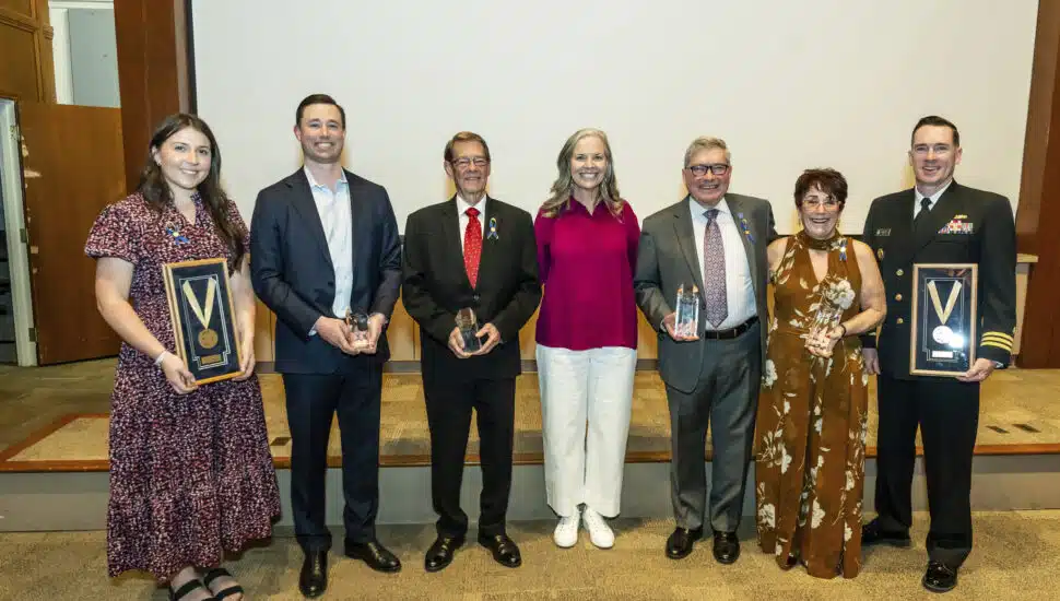 Widener University Alumni Award recipients pose with Widener University President Stacey Robertson (center).
