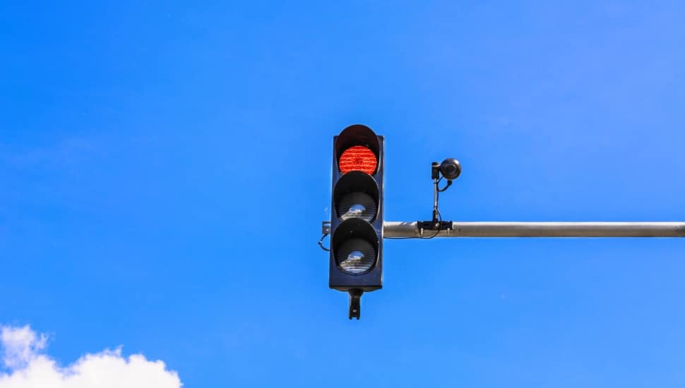 A camera mounted on a red light.