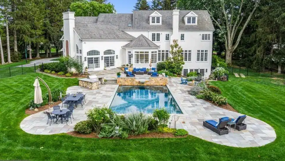 The rear yard of the Aronimink Golf Club mansion with saltwater pool and lounge area that is next to the 4th hole fairway of the Aronimink Golf Course.
