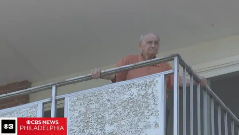 A resident of Newtown Towers looks out from his balcony during a multi-day power outage that left the senior residents without air conditioning, refrigeration or elevators.