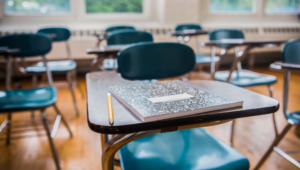 A school classroom with empty desks.