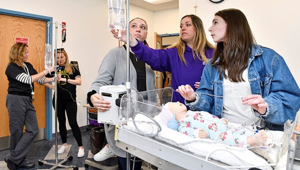 Nursing students tend to baby doll patient.