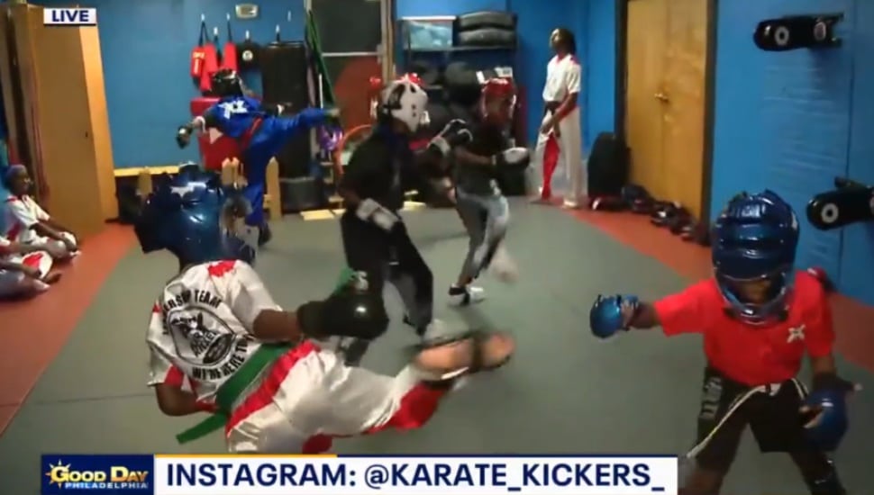 Two kids at Karate Kickers in Drexel Hill challenge each other in a match.