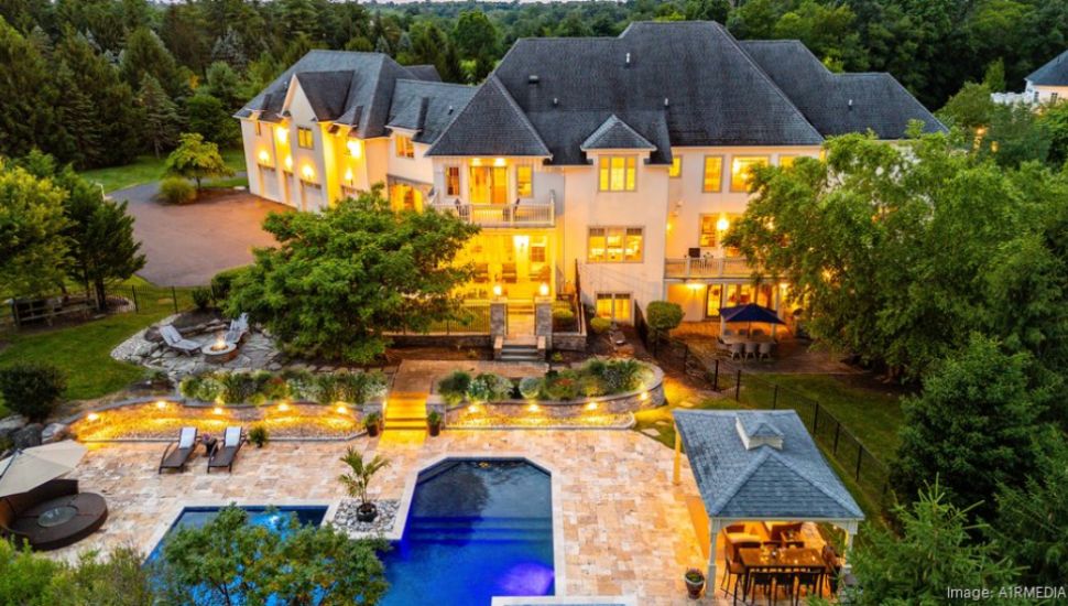 An aerial view of a French-inspired mansion in Newtown for sale.