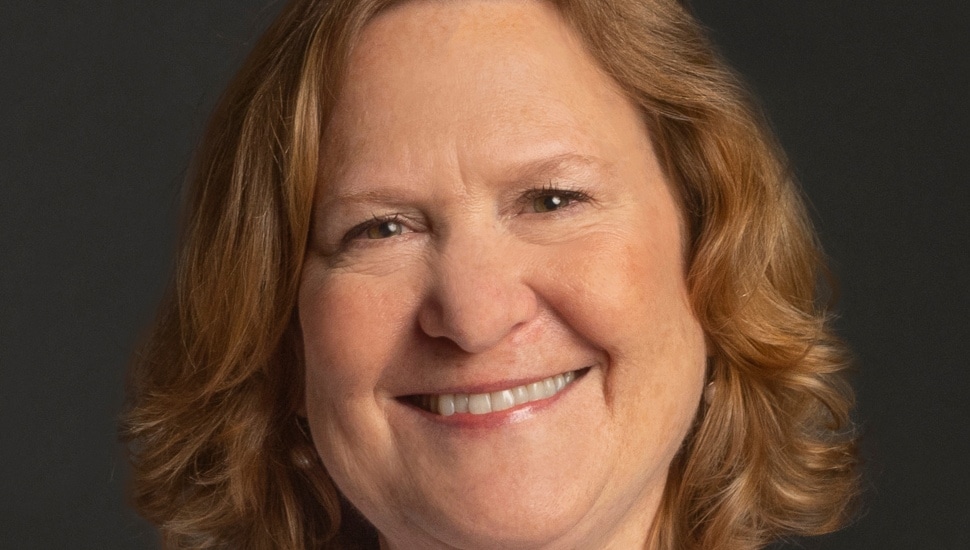 Headshot of middle-aged woman with brown hair.