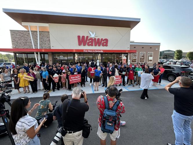 A crowd and photographers gather for the grand opening of Kentucky's first Wawa store.