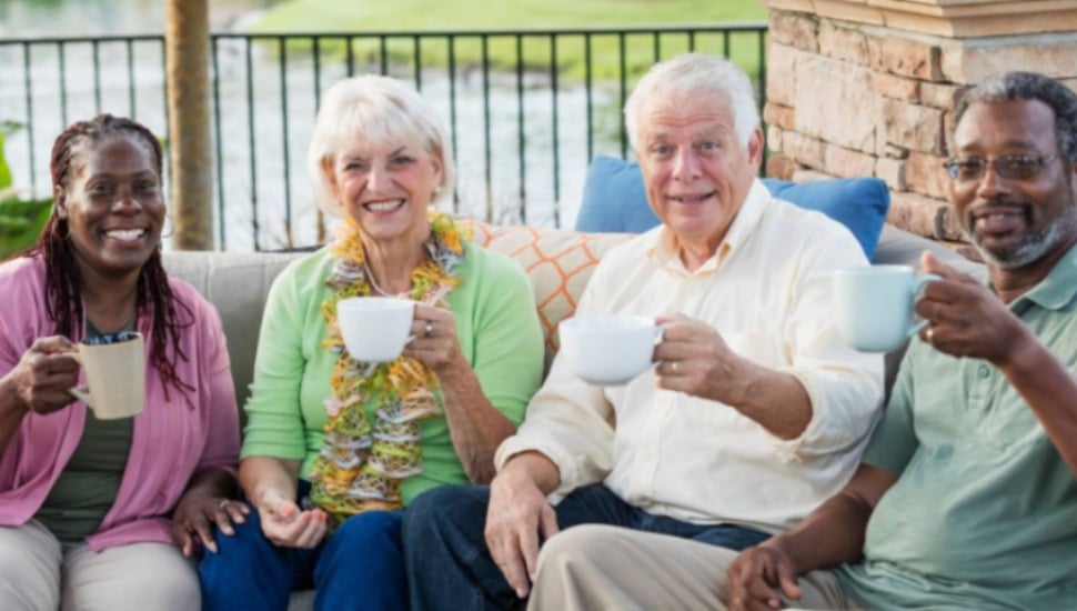 A group of seniors drinking coffee at their senior living community