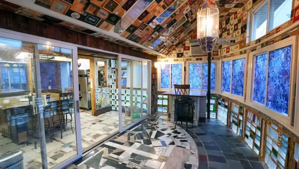The sunroom of Justine May's Upper Darby home before its $150,000 makeover. It is wallpapered with cigar boxes.