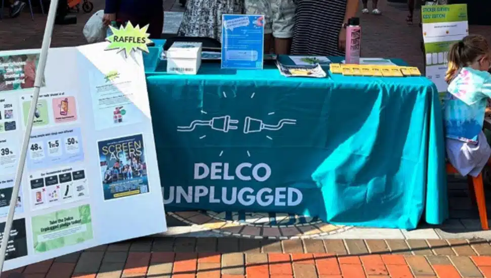 Table and poster board with advocacy group's signage.