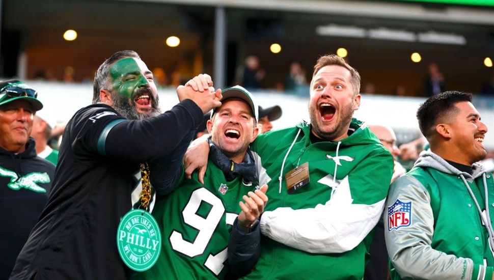 Fans cheer at a football game.
