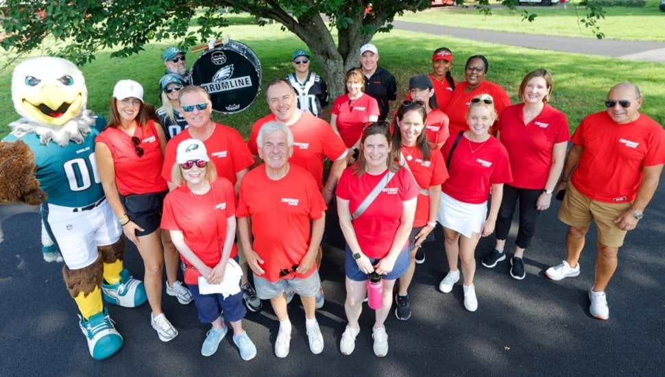 Group photo of bank volunteers with red shirts.