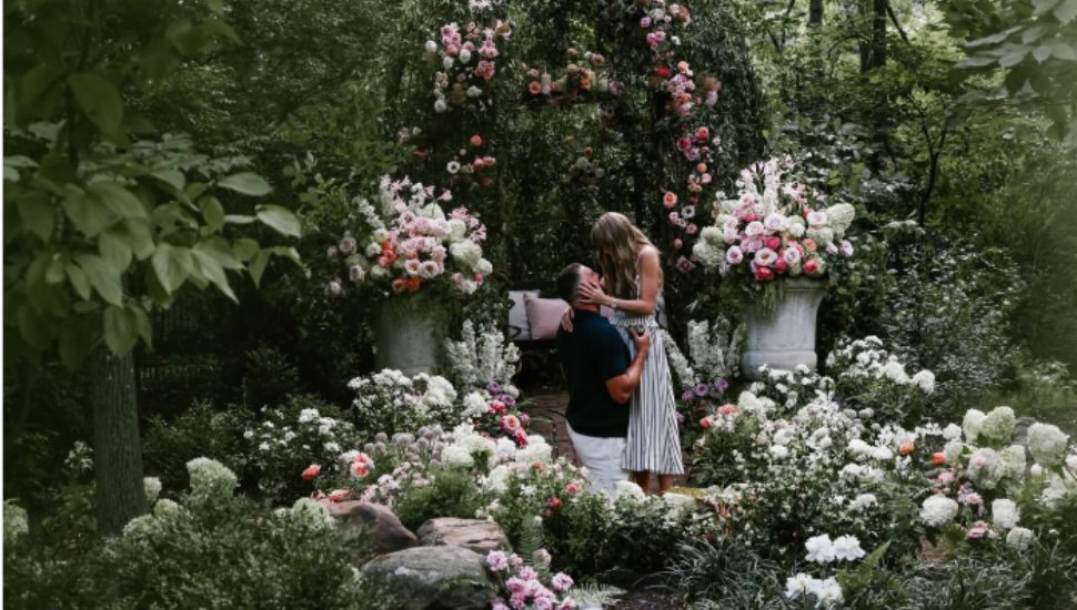 Taylor Swift and Travis Kelce in a flower garden.