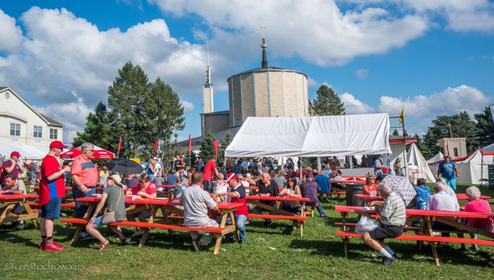 People at picnic tables during the Polish American Family Festival and Country Fair.