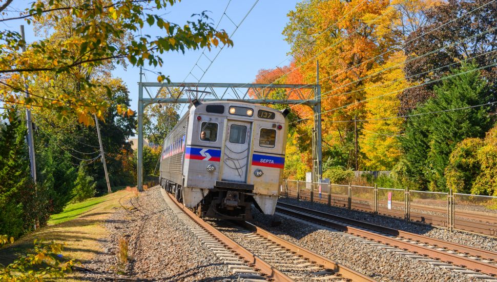A SEPTA train travels the tracks on a beautiful fall day.