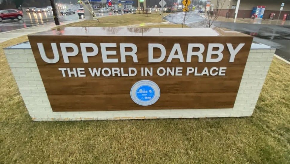 A sign at the Upper Darby Township border declaring Upper Darby as "The World in One Place."