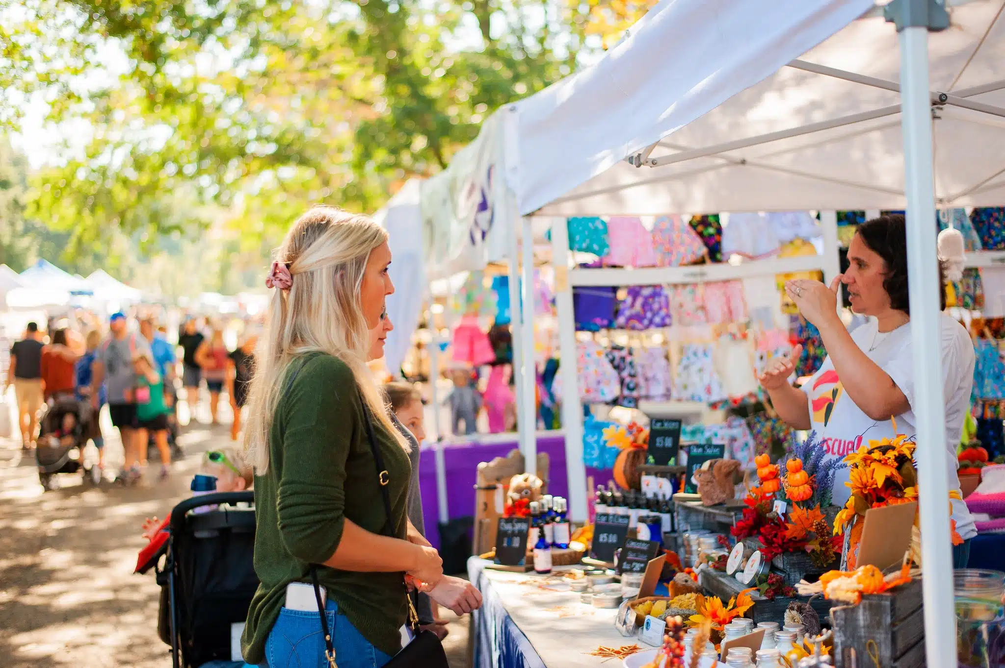 Two women check out a booth at last year’s arts and crafts festival at Linvilla Orhcards.
