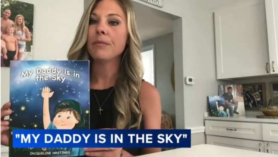 Jacqueline Hastings holds up a copy of her book, "My Daddy Is in the Sky."