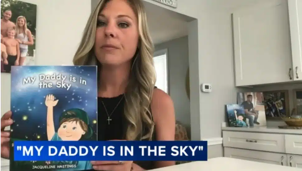 Jacqueline Hastings holds up a copy of her book, "My Daddy Is in the Sky."